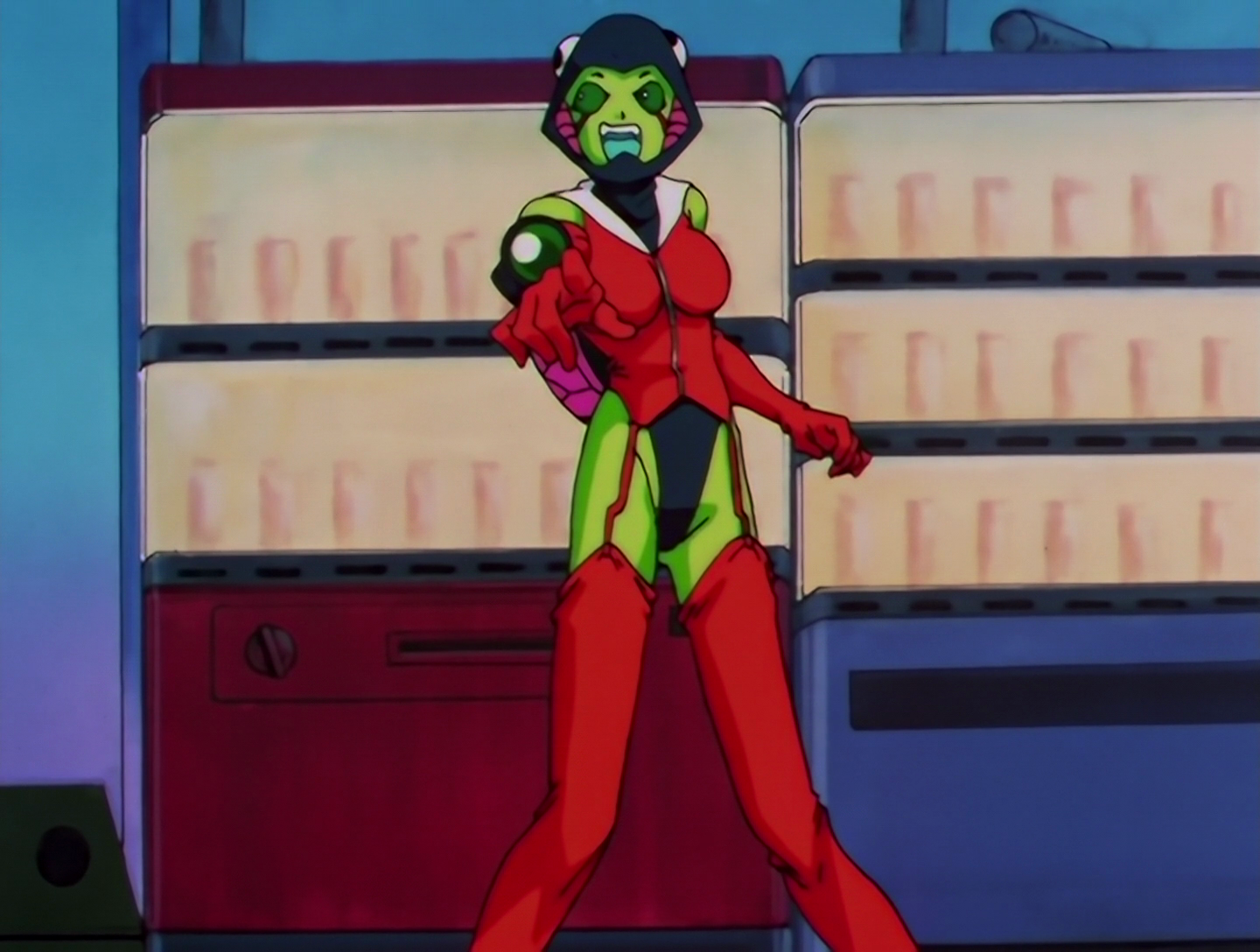 Sailor Gekisha, a Phage from Sailor Moon episode 175. She has green skin and eyes, and her outfit consists of red gloves, stockings and jacket with a white sailor collar, a reptilian hood and… oh wow, those swimsuit bottoms do not look comfortable. She also has a camera with a green lens attached to one sleeve